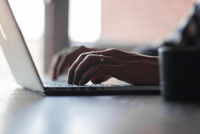 hands on a laptop keyboard