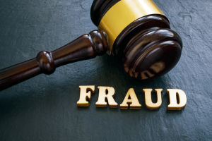 A gavel and the words spelled out for fraud