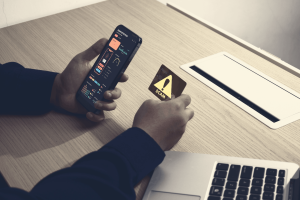 A man getting notified of a wire fraud on his phone